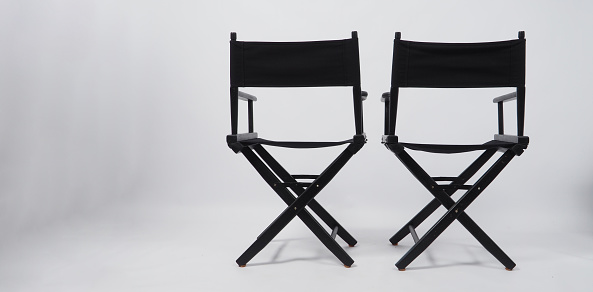 Back of black two director chair use in video production or movie and cinema industry on white background.