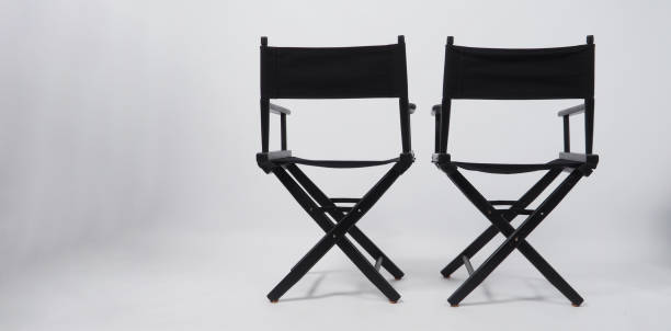 Back of black two director chair use in video production or movie and cinema industry on white background. Back of black two director chair use in video production or movie and cinema industry on white background. director stock pictures, royalty-free photos & images
