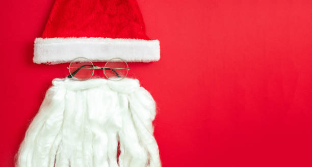 istock Santa Claus hat beard and mustache on red color background 1346196953