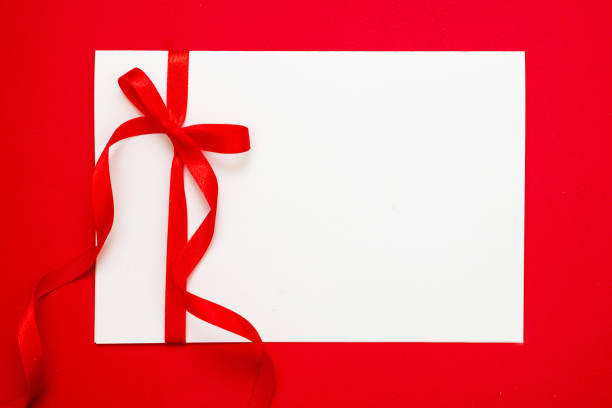 istock Gift card blank, red ribbon bow on red background, Christmas, valentine present concept 1346196955