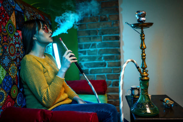 istock Hippie woman smoking hookah 1346197186