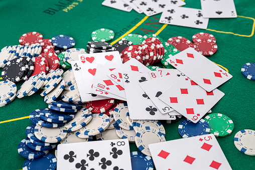 On The Green Poker Table Are Playing Cards And Lots Of Colored Chips ...