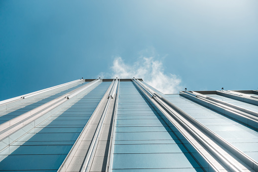 underside panoramic and perspective view to steel blue glass high rise building skyscrapers, business concept of successful industrial architecture