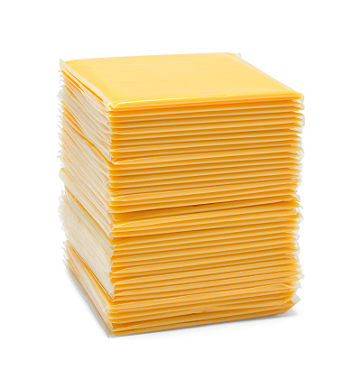 Pile of Slice Cheese Cut Out on White.