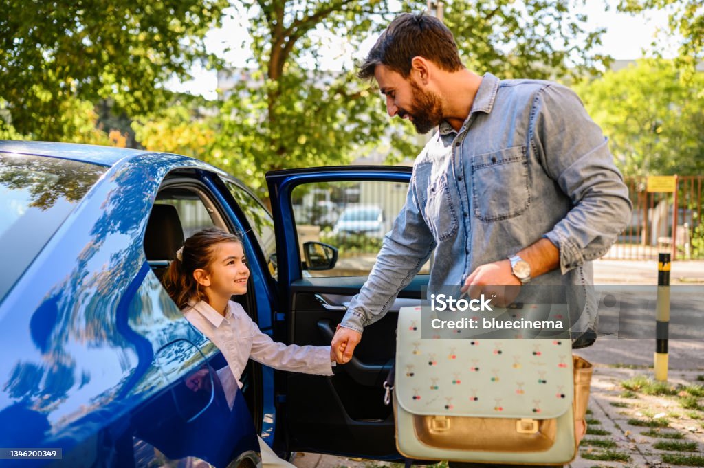 Father taking his daughter to school Car Stock Photo
