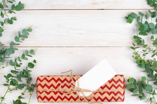 istock empty xmas wish list with little gift on wooden background 1346200621
