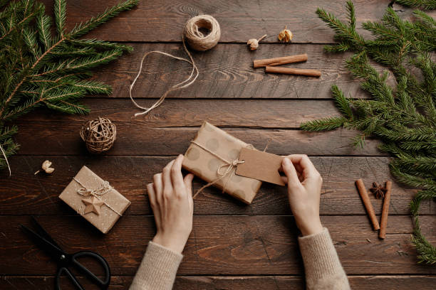 istock Wrapping Christmas Gift on Wooden Background 1346201613