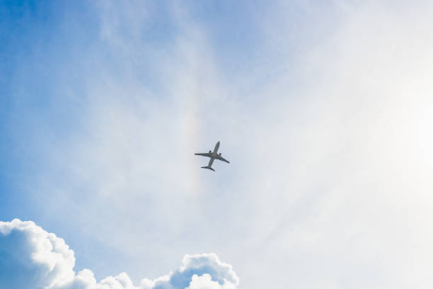 istock Airplane rising in the clouds 1346202945