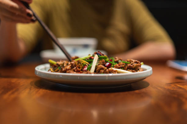 istock A lady uses chopsticks to pick up fried meat on a plate 1346203053
