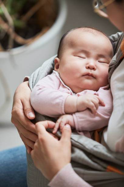 istock Baby sleeping on the mothers hands 1346203453