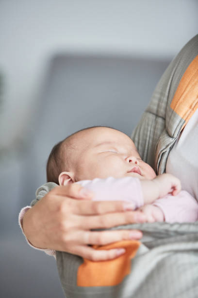 istock Sleeping baby on the mothers hands 1346203458