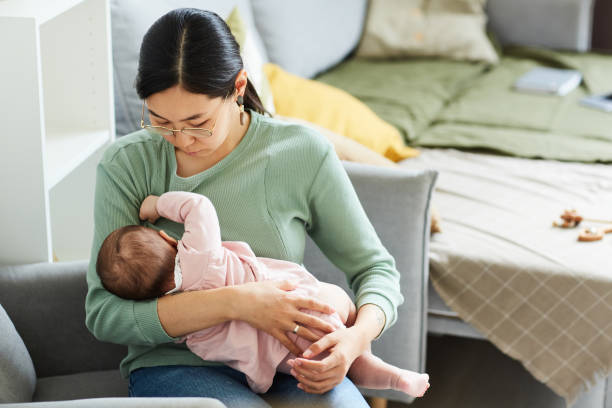 istock Mother feeding her baby 1346203512