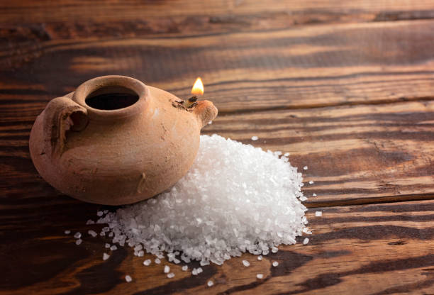 a clay lamp and pile of salt illustrating jesus teachings"n - teachings imagens e fotografias de stock