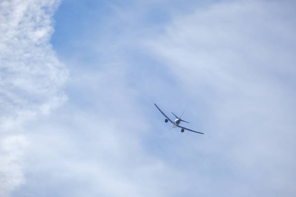 istock flying plane against the background of blue sky and clouds 1346204669