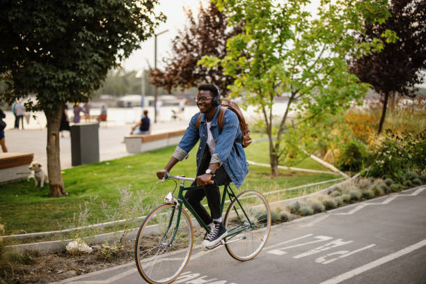 istock Young man cycling down the street 1346206579