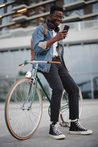 istock Handsome man sitting on the bike and using phone 1346206868