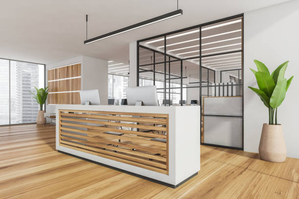 istock Corner of white office reception with wood panels and open space 1346207053