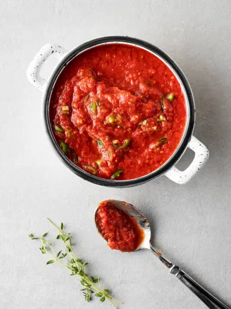 Photo of Homemade tomato sauce in the saucepan, Cooking and seasoning tomato sauce, Tomato Paste, Preparing fresh tomato sauce,