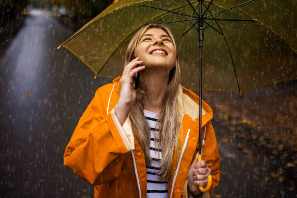istock Beautiful young woman enjoying a rainy day 1346215533