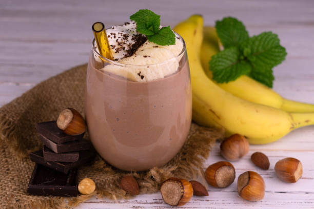 istock Chocolate banana smoothie with cream and nuts. 1346215574