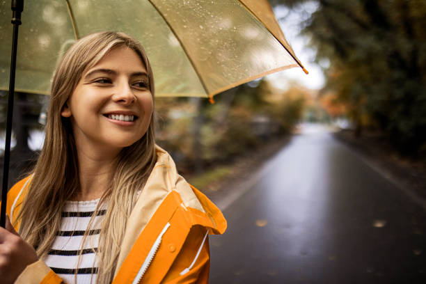 istock Beautiful young woman enjoying a rainy day 1346215588