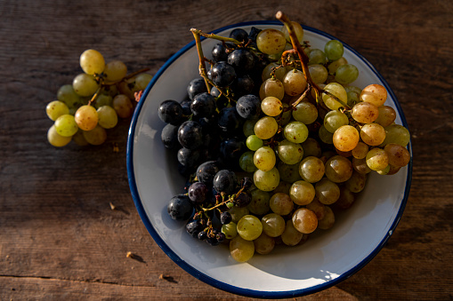 Top view of fresh grapes on wooden table