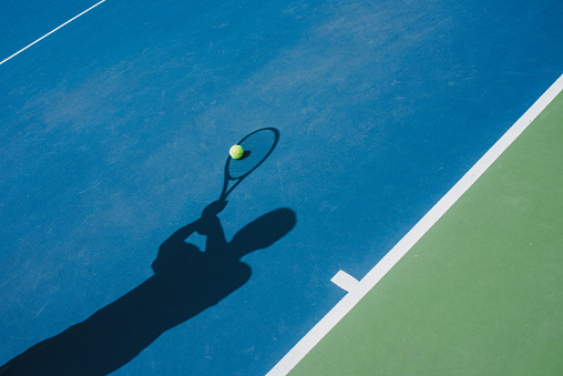Shadow of Tennis Player catching the ball