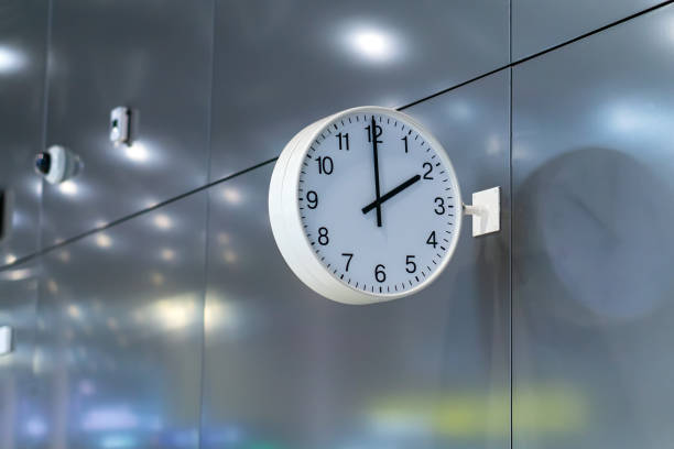 istock A white public clock on a metal wall. 1346219534