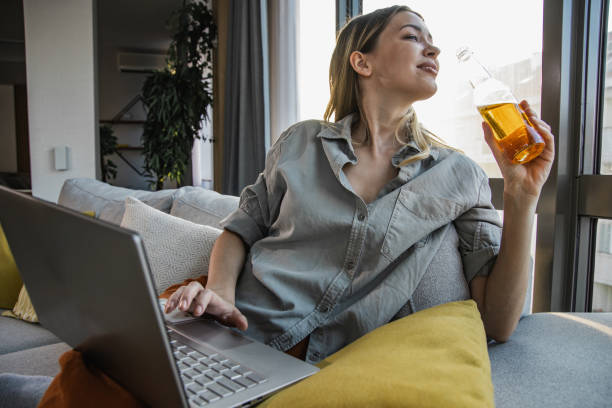 istock Young woman relaxing at home and using laptop 1346221766