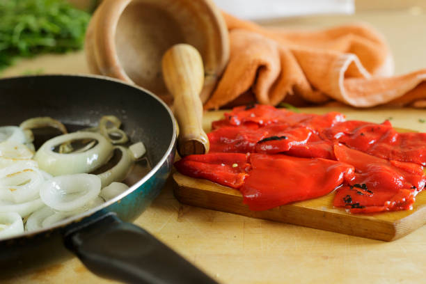 Grilled vegetables on cutting board over wooden table background. View from above-