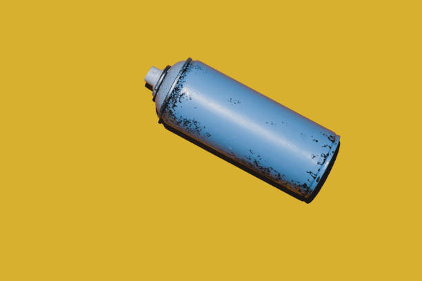 istock Can of spray paint isolated on yellow background 1346225292