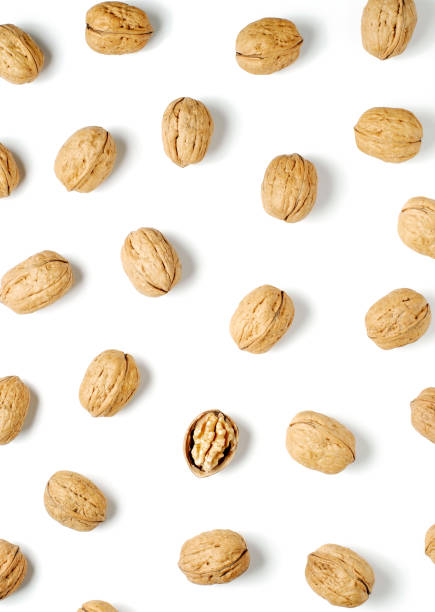 istock Walnuts on a white background. Nut - a source of vitamins and useful trace elements. Flat top view. 1346225297