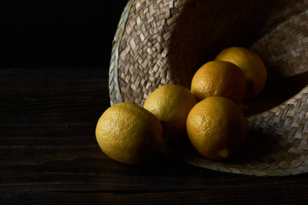 Lemons inside a farmer's hat with copy space in black.