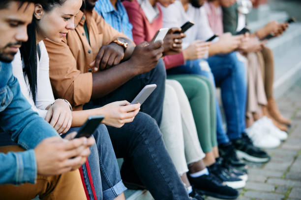 istock Large group of students using their smart phones at campus. 1346225995