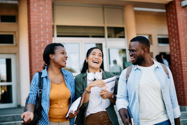 istock Group of cheerful multiracial group students having fun after the lecture at campus. 1346226068