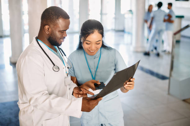 istock Happy medical students analyzing X-ray scan in a hallway at medical university. 1346227075