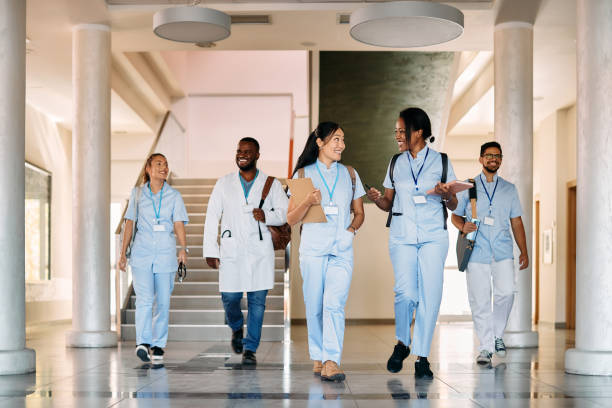 istock Multi-ethnic group of happy medical and nursing students talking through a hallway and talking. 1346227264