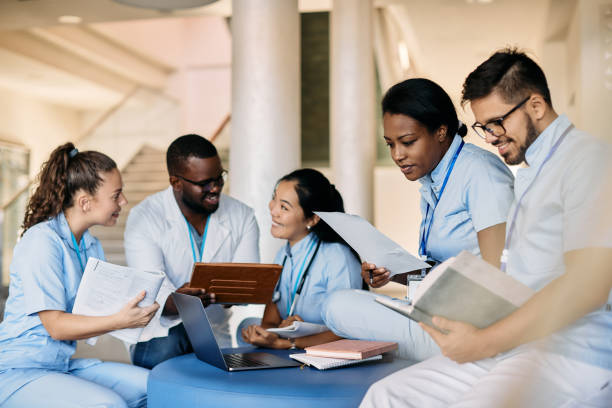 Multi-ethic group of medical students studying in hallway at the university.