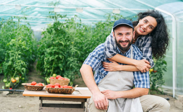 istock Couple farmers having fun, embracing 1346228680