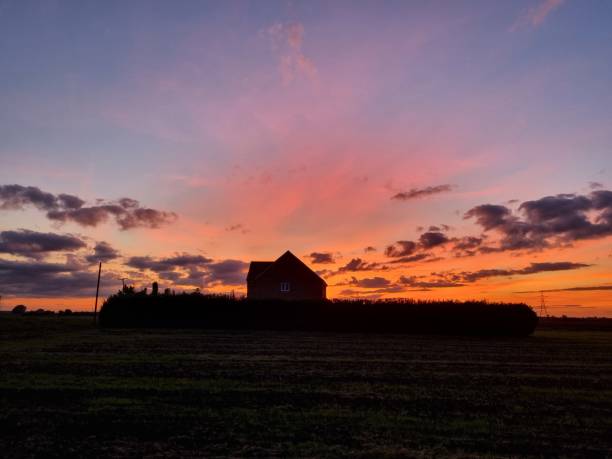 istock Orange Sunset behind a House (close) 1346228897