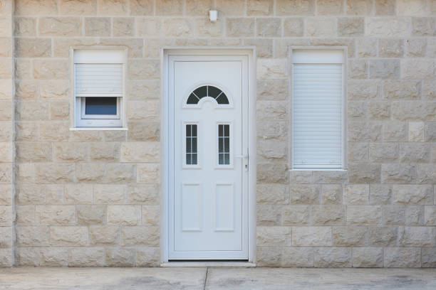White front door and stone wall in a residential building.