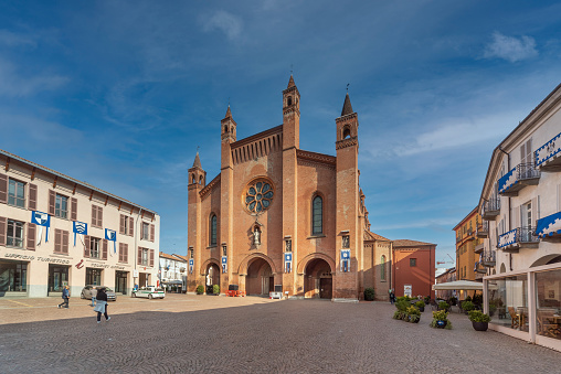 Alba, Cuneo, Piedmont, Italy - October 12, 2021: Piazza Duomo with  Cathedral of San Lorenzo and the palaces with the banners of the historic donkey race at the time of the truffle fair