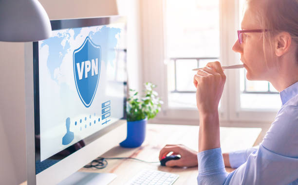 VPN secure connection for freelancer Person using Virtual Private Network technology on computer to create encrypted tunnel to remote server on internet to protect data privacy, home office. stock photo