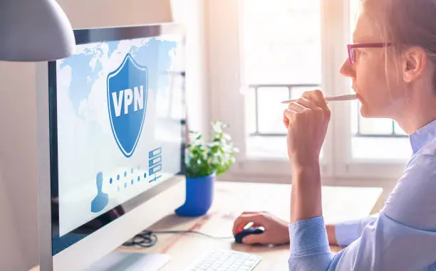 Photo of VPN secure connection for freelancer Person using Virtual Private Network technology on computer to create encrypted tunnel to remote server on internet to protect data privacy, home office.