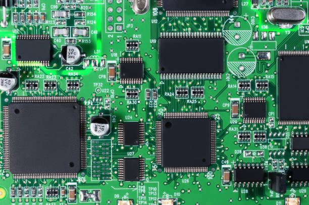 istock electronic circuit board with passive and active circuit components and IC close-up 1346235427
