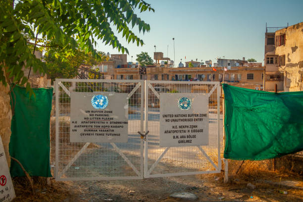 Nikosia, July 2011, UN-area entrance, warning panels, semi-destroyed buildings in the background.