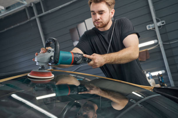 istock Man polishing car with power buffer machine in automobile repair 1346235650