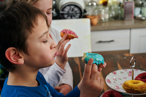 Kids Eating Donuts with Icing and Chocolate