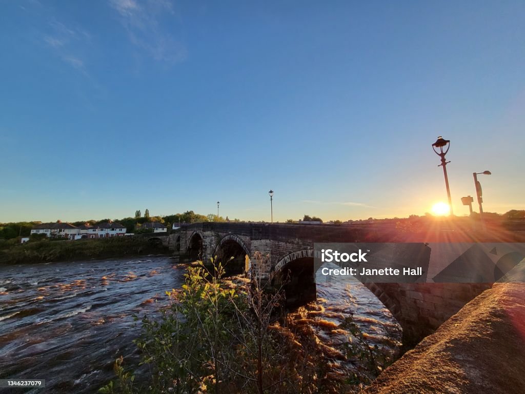 Sunrise Sunrise coming over the Old Penwortham Bridge in Preston, Lancashire Preston - England Stock Photo