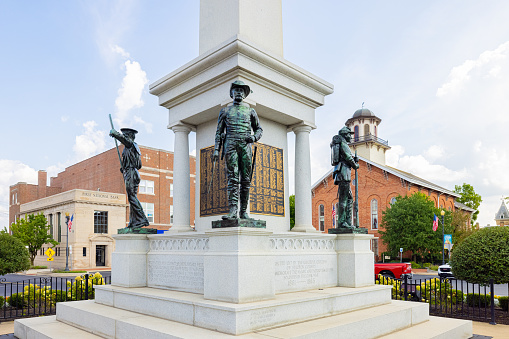 Angola, Indiana, USA - August 21, 2021: The Steuben County Soldiers Monument in downtown, with the Courthouse in the background